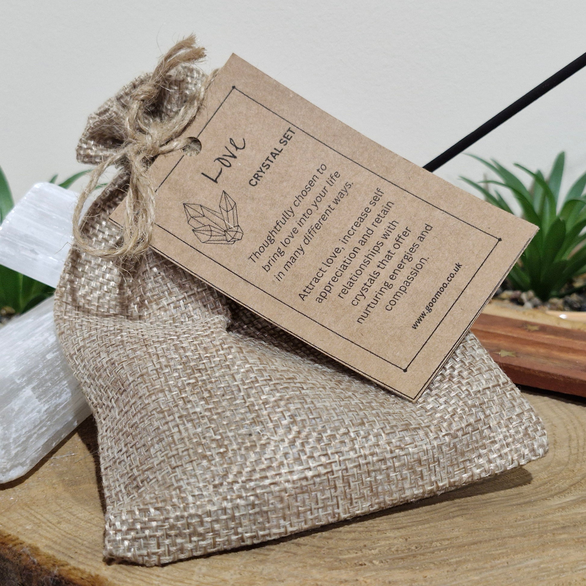 An eco friendly jute string bag containing six specially selected tumblestones. Finished with a kraft card tag explaining the meanings and uses of crystal contents