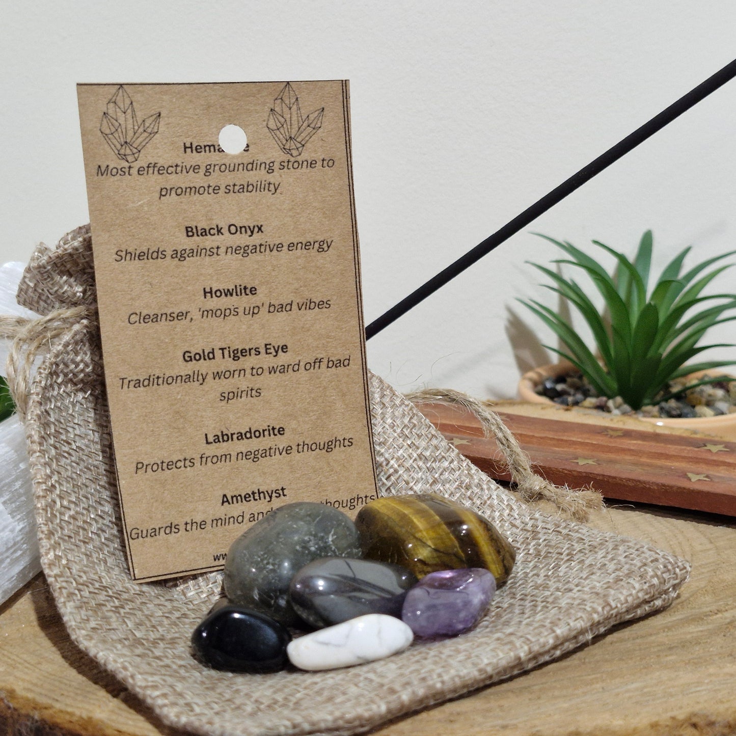 An eco friendly jute string bag containing six specially selected tumblestones. Finished with a kraft card tag explaining the meanings and uses of crystal contents